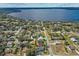 An aerial view of a lakeside neighborhood featuring lush trees, serene water views, and multiple houses at 12442 Sunshine Dr, Clermont, FL 34711