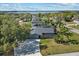 Aerial view showcases the property's proximity to a lake, lush landscaping, and inviting backyard at 12442 Sunshine Dr, Clermont, FL 34711