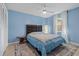 Brightly painted blue bedroom with ceiling fan and side tables at 12442 Sunshine Dr, Clermont, FL 34711