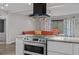 Updated kitchen highlighting a stainless steel range oven and modern range hood at 12442 Sunshine Dr, Clermont, FL 34711