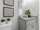 Bright bathroom featuring a granite countertop, modern fixtures, and decorative plants at 1251 Big Bass Dr, Ormond Beach, FL 32174