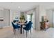 An elegant dining room features a marble-top table and blue velvet chairs at 1251 Big Bass Dr, Ormond Beach, FL 32174