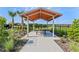 Outdoor community gazebo featuring a wood ceiling, metal beams and posts, and a picnic table and bench at 1251 Big Bass Dr, Ormond Beach, FL 32174