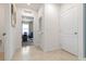 Hallway showing neutral paint, beige tile floors, white doors and an adjacent room at 1251 Big Bass Dr, Ormond Beach, FL 32174