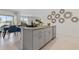 Kitchen island with sink and seating overlooks dining area with table set for meal, showcasing an open-concept design at 1251 Big Bass Dr, Ormond Beach, FL 32174