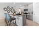 Stylish kitchen island with granite countertop, seating, and modern gray cabinetry offers a great space for entertaining at 1251 Big Bass Dr, Ormond Beach, FL 32174