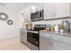 Functional kitchen area featuring granite countertops, stainless steel appliances, and modern cabinetry, ideal for culinary creations at 1251 Big Bass Dr, Ormond Beach, FL 32174