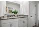 Bright bathroom featuring a double sink vanity with granite countertops, white cabinets, and modern fixtures at 1255 Big Bass Dr, Ormond Beach, FL 32174