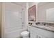 Clean bathroom featuring a shower/tub, a sink with granite countertops and modern fixtures at 1255 Big Bass Dr, Ormond Beach, FL 32174