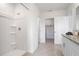 Bathroom with a glass shower and granite-topped double sink vanity with tiled floors at 1255 Big Bass Dr, Ormond Beach, FL 32174