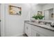 Bathroom featuring a double sink vanity with granite countertops, white cabinets, and a large mirror at 1255 Big Bass Dr, Ormond Beach, FL 32174