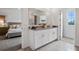 A bathroom with double granite sinks and a view leading to the main bedroom at 1255 Big Bass Dr, Ormond Beach, FL 32174