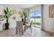 Bright dining area featuring a modern table set, decorative wall art, and a sliding door with lake views at 1255 Big Bass Dr, Ormond Beach, FL 32174