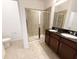 Modern bathroom with double vanity, stone countertops, and a large glass-enclosed shower at 12615 Salomon Cove, Windermere, FL 34786