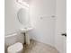 Powder room with a pedestal sink and an oval mirror at 12615 Salomon Cove, Windermere, FL 34786