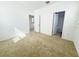 Carpeted bedroom with two doors, one leading to a bathroom with tiled floors at 12615 Salomon Cove, Windermere, FL 34786