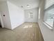 Bright bedroom features neutral carpet, white walls and natural light from the window with horizontal blinds at 12615 Salomon Cove, Windermere, FL 34786