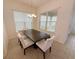 Dining room with a dark wood table and white chairs, illuminated by a chandelier at 12615 Salomon Cove, Windermere, FL 34786