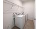 A laundry room with a washer, dryer, and overhead shelving at 12615 Salomon Cove, Windermere, FL 34786