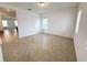 Bright living room with tile flooring and natural light from two windows at 12615 Salomon Cove, Windermere, FL 34786