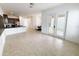 Open-concept living room featuring tile flooring, a modern kitchen, and sliding doors to the outdoor area at 12615 Salomon Cove, Windermere, FL 34786