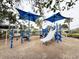 View of a blue playground with a slide, climbing structures, and shade canopies at 12615 Salomon Cove, Windermere, FL 34786