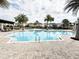 Community pool featuring a clear blue swimming area with lounge chairs nearby at 12615 Salomon Cove, Windermere, FL 34786