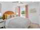 Bright bedroom featuring a patterned coverlet, an orange headboard and natural light at 1319 Tarflower Dr, Winter Springs, FL 32708