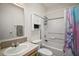 Cozy bathroom featuring a tub-shower combo, vanity with sink, and a storage cabinet for essentials at 13201 Plum Lake Cir, Minneola, FL 34715