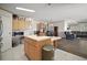 Bright kitchen with wooden cabinets, island, and modern appliances open to the dining and living areas at 13201 Plum Lake Cir, Minneola, FL 34715