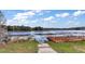 Scenic lake view from a home's community trail, inviting peaceful strolls and appreciation of the beautiful natural surroundings at 13201 Plum Lake Cir, Minneola, FL 34715