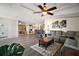 Open concept living room flowing into the kitchen, featuring stylish flooring and ample space for relaxation and gatherings at 13201 Plum Lake Cir, Minneola, FL 34715