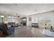 Bright and airy living room with modern flooring, a stone fireplace, and large windows, creating a welcoming and comfortable atmosphere at 13201 Plum Lake Cir, Minneola, FL 34715