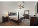 Main bedroom with wooden floors, a ceiling fan and a dark wood bed frame and dressers at 13201 Plum Lake Cir, Minneola, FL 34715