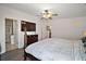 Relaxing main bedroom with ensuite bath, a ceiling fan, and a mounted TV for entertainment at 13201 Plum Lake Cir, Minneola, FL 34715