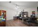 Bright home office featuring hardwood floors, a ceiling fan, and built-in shelving at 13201 Plum Lake Cir, Minneola, FL 34715