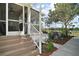 Relaxing screened-in porch with steps down to patio area, perfect for enjoying the outdoors at 13201 Plum Lake Cir, Minneola, FL 34715