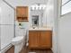 Well-lit bathroom featuring a vanity with wood cabinets and a glass-enclosed shower at 133 Hillcrest Dr, Davenport, FL 33897