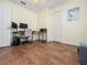 Versatile bedroom featuring wood floors, a ceiling fan, and a dedicated computer setup at 133 Hillcrest Dr, Davenport, FL 33897