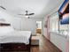 Bright bedroom featuring wood floors, a TV, and access to an ensuite bathroom at 133 Hillcrest Dr, Davenport, FL 33897