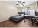 Serene bedroom featuring a gray platform bed, a ceiling fan, and a modern computer setup at 133 Hillcrest Dr, Davenport, FL 33897