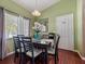 Cozy dining room features a modern table set, natural light and a stylish mirror at 133 Hillcrest Dr, Davenport, FL 33897