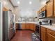 This spacious kitchen is equipped with stainless steel appliances and wood cabinets at 133 Hillcrest Dr, Davenport, FL 33897