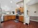 The kitchen features wood cabinets, stainless steel appliances, and a view into the living room at 133 Hillcrest Dr, Davenport, FL 33897