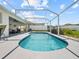 A pristine screened-in pool area features comfortable seating, a ceiling fan and space for entertaining at 133 Hillcrest Dr, Davenport, FL 33897