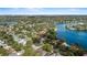 Aerial view showcases the lakefront home with lush landscaping and mature trees, with lake views at 1355 S Summerlin Ave, Orlando, FL 32806