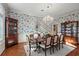 Formal dining room with floral wallpaper, hardwood floors, and a large crystal chandelier at 1355 S Summerlin Ave, Orlando, FL 32806