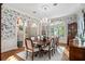 Charming dining room with floral wallpaper, hardwood floors, and a chandelier above the table at 1355 S Summerlin Ave, Orlando, FL 32806