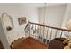 Elegant curved staircase overlooks the entryway with chandelier and marble floor at 1355 S Summerlin Ave, Orlando, FL 32806