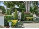 Beautifully landscaped garden with mature trees, manicured shrubs, and a charming stone fountain, adding elegance at 1355 S Summerlin Ave, Orlando, FL 32806